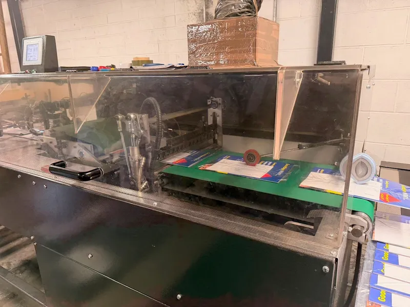 Close-up of the inserting line mechanism preparing a mailing