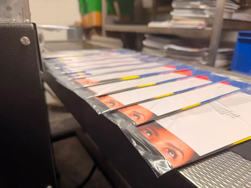 A polywrapped magazine catching the light, ready for posting