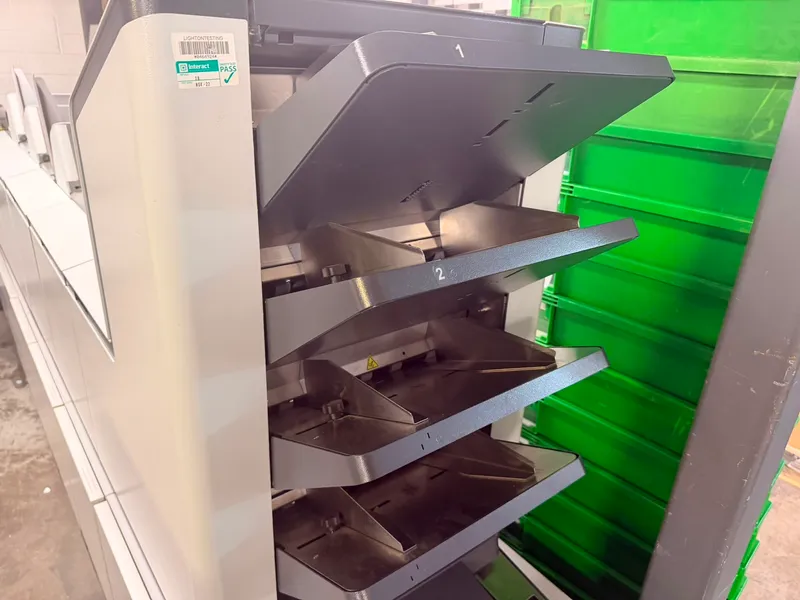 Numbered stacker trays sorting a mailing on our inserting line